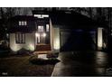 Modern house exterior at night, with lights illuminating the home and landscaping at 8309 Stryker Ct, Raleigh, NC 27615