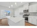 Modern kitchen featuring a large island, stainless steel appliances, and ample cabinet space at 907 Montague Ave, Durham, NC 27703