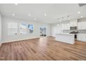 Bright living area with hardwood floors, white kitchen, island and slider door to fenced yard at 907 Montague Ave, Durham, NC 27703