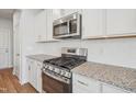 Close-up view of modern stainless steel appliances and granite countertops in the kitchen at 911 Montague Ave, Durham, NC 27703