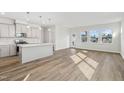 Bright open-concept living space with light wood floors and kitchen with island at 913 Montague Ave, Durham, NC 27703