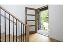 Open entryway with hardwood floors, modern staircase, and a view to the backyard at 914 Ardmore Dr, Durham, NC 27713