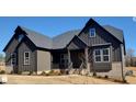 Dark gray siding, brick accents, and a welcoming front porch characterize this craftsman style home at 1 Kelsey Ct, Hillsborough, NC 27278