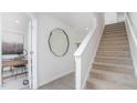 Modern staircase with carpet runner and light-filled entryway at 111 Reagan Crest Dr, Clayton, NC 27520