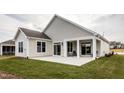 Covered patio with seating area and grassy backyard at 1254 Linkwood, Homesite 48, Fuquay Varina, NC 27526