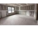 Empty bedroom with drywall, one window, and prepped for flooring and paint at 18 Bonnybrook Ct, Selma, NC 27576