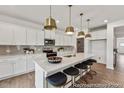 Well-lit kitchen showcases a large island with seating, stainless steel appliances, and white cabinetry at 300 Nathan Dr # 44P, Lillington, NC 27546