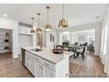 Open-concept kitchen and dining area with island seating and views into the living space at 300 Nathan Dr # 44P, Lillington, NC 27546