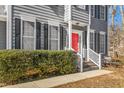 Gray house exterior showcasing a red front door and manicured shrubs at 300 Ashwick Dr, Efland, NC 27243