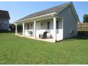 A covered porch with rocking chair is the focus of this home's side exterior at 35 Meadow Ln, Franklinton, NC 27525
