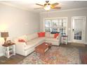 Bright living room featuring a large sectional sofa, ceiling fan, and area rug at 35 Meadow Ln, Franklinton, NC 27525