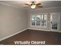 Spacious living room with hardwood floors, a ceiling fan, and bright natural light at 35 Meadow Ln, Franklinton, NC 27525