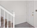 White entryway with carpeted stairs and white door at 3751 Yorktown Pl, Raleigh, NC 27609