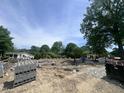 Image shows new construction with the foundation prepared and materials staged, ready to begin building at 403 Carolyn Ct, Cary, NC 27511