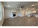 Bright and airy living room seamlessly connected to the kitchen, featuring a fireplace and hardwood floors at 404 Brodie Rose Landing Way, Smithfield, NC 27577
