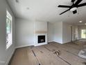 Inviting living room with a modern fireplace, awaiting your personal touch at 404 Brodie Rose Landing Way, Smithfield, NC 27577