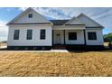 Beautifully landscaped modern farmhouse-style home with a well kept front yard at 541 Delma Grimes Rd, Coats, NC 27521