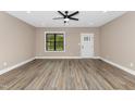 Bright living room featuring wood-look flooring, a ceiling fan, and plenty of natural light at 541 Delma Grimes Rd, Coats, NC 27521