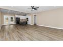 Open concept living space with wood floors, connecting the living room, dining area, and kitchen at 541 Delma Grimes Rd, Coats, NC 27521