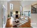Virtually staged living room with hardwood floors and fireplace at 5621 Voorhees Ln, Holly Springs, NC 27540
