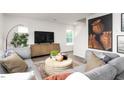 Cozy living room with sectional sofa and a large statement art piece at 6012 Sodium St, Raleigh, NC 27610