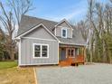 Charming gray two story home featuring a welcoming front porch at 624 S Eighth St, Mebane, NC 27302