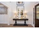 Elegant entryway, console table, butterfly wallpaper, hardwood floors at 63 Rice Rd # 01, Zebulon, NC 27597