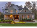Stunning two-story home with warm lighting, beautifully landscaped at 63 Rice Rd # 01, Zebulon, NC 27597