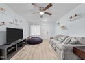 Living room with gray sofa, tv, and wood-look floors at 7002 Longstreet Dr # C, Raleigh, NC 27615