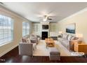 Virtually staged living room features built-in shelving and fireplace at 7434 Randshire Way, Raleigh, NC 27616