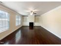 Spacious living room with hardwood floors and a fireplace at 7434 Randshire Way, Raleigh, NC 27616