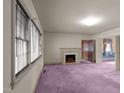 Spacious living room with fireplace and purple carpet at 809 Jeffreys Rd, Rocky Mount, NC 27804