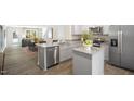 Open concept kitchen with island, granite countertops, and stainless steel appliances at 8611 Brixton Shay Dr, Raleigh, NC 27616