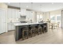 Stylish kitchen island offers seating for four, adjacent to a bright, eat-in dining space at 8817 Tartan Clan Dr, Angier, NC 27592