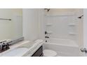 Bathroom with shower/tub combo, granite countertop, and dark vanity at 104 Barn Door Dr, Lillington, NC 27546