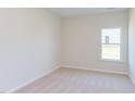 Simple bedroom with carpeted floor and a window at 104 Barn Door Dr, Lillington, NC 27546