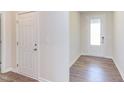 Light-colored foyer with wood-look flooring and two doors at 104 Barn Door Dr, Lillington, NC 27546