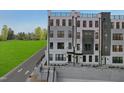 Stunning townhome showcasing a contemporary design with gray and white facade, large windows, and a rooftop terrace at 109 Ailey Brook Way # 200, Wake Forest, NC 27587