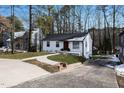 Front view of a renovated white brick house with a walkway at 1128 E Geer St, Durham, NC 27704