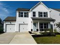 Two-story white house with a two-car garage and front porch at 1312 Anthony Wood Ct, Fuquay Varina, NC 27526
