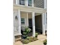 Inviting front porch with seating area and potted plants at 166 Gulley Glen Dr, Garner, NC 27529