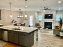 Open concept kitchen with island, stainless steel appliances, and hardwood floors at 166 Gulley Glen Dr, Garner, NC 27529
