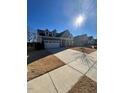 Two-story house with blue siding, attached garage, and a manicured lawn at 1751 Flint Valley Ln, Apex, NC 27502