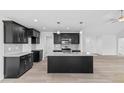 Modern kitchen with granite countertops and dark cabinetry at 250 Eason Creek Way, Clayton, NC 27527