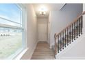 Inviting entryway with natural light and view of the staircase with grey walls at 251 Hopewell Br Ct, Smithfield, NC 27577