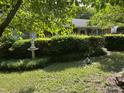 Landscaped front yard with a statue and decorative garden ornaments at 2612 Academy St, Sanford, NC 27332