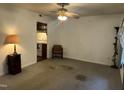 The living room has neutral walls and carpet with a ceiling fan and access to the kitchen at 2612 Academy St, Sanford, NC 27332