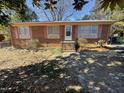 Brick ranch home with pink shutters and a short stairway at 2801 O'Shanter Pl, Raleigh, NC 27604