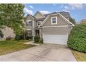 A two-story home with a driveway and a two car garage and neutral siding at 3905 Song Sparrow Dr, Wake Forest, NC 27587