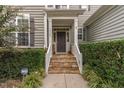 Close-up of a charming front porch with stone steps, white railings, and a welcoming entrance at 3905 Song Sparrow Dr, Wake Forest, NC 27587